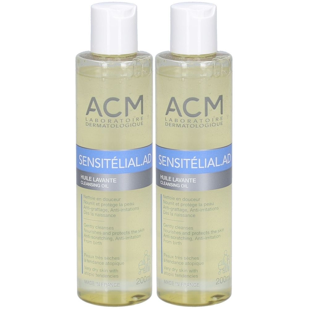 Twee flessen met witte doppen. Opschrift: ACM Laboratoire Dermatologique, Sensitélial AD, Huile Lavante, Cleansing Oil.