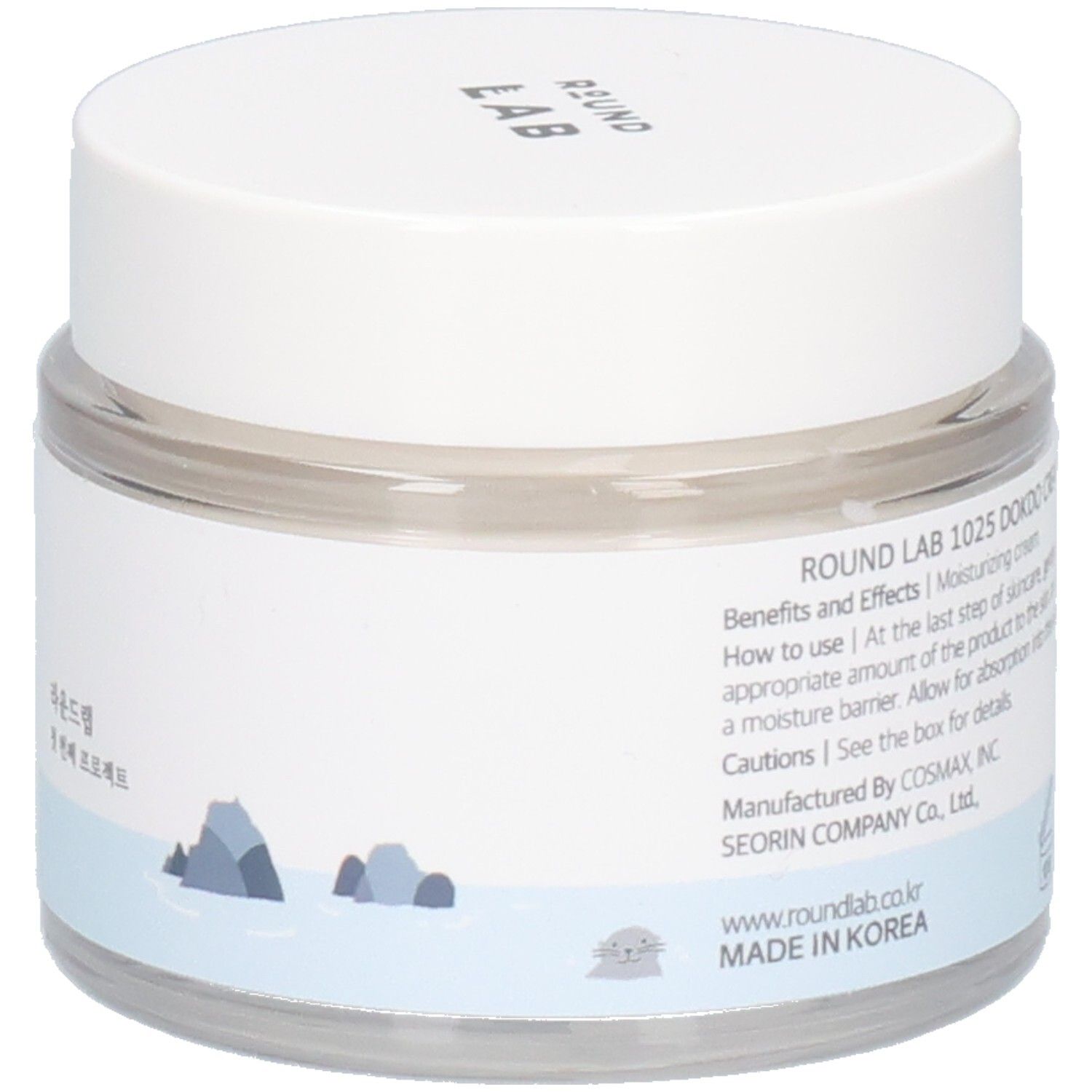 Ronde, transparante pot met witte deksel. Etiket met tekst en recyclingsymbolen. "ROUND LAB" bovenaan.