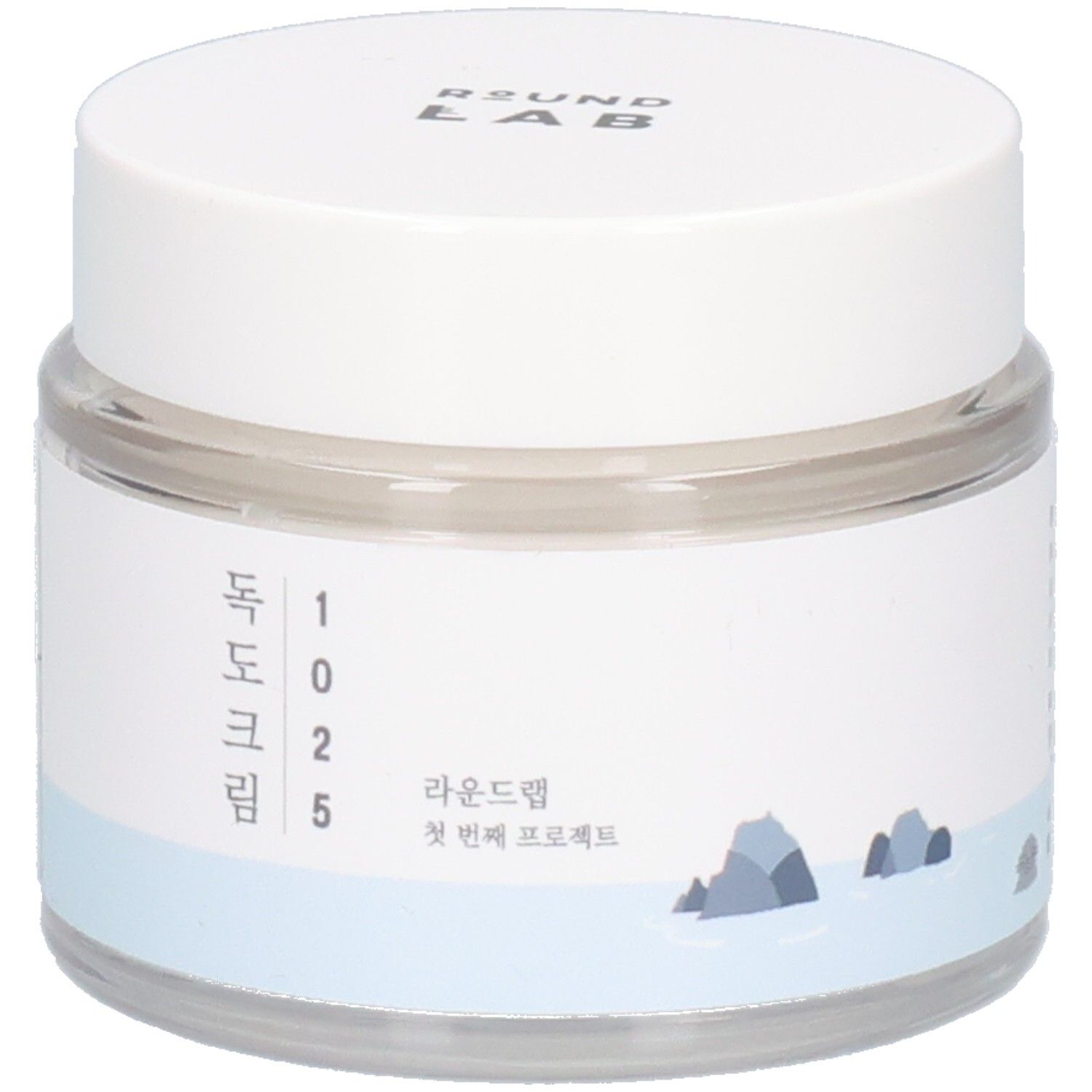 Ronde, transparante pot met witte deksel. Etiket met Koreaanse tekst en logo. "ROUND LAB" bovenaan.