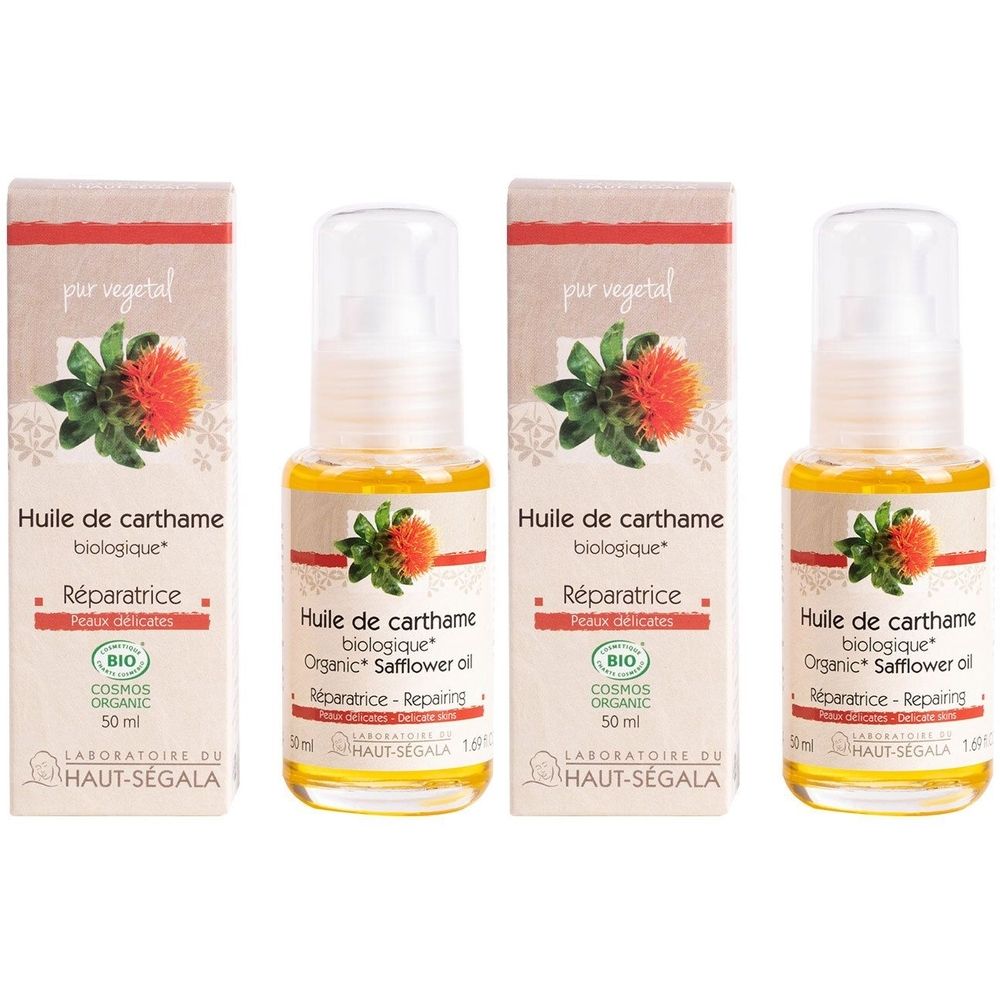 Vier flessen gele olie met verstuiver en dozen. Opschrift: Huile de carthame biologique, Réparatrice, BIO-certificering.
