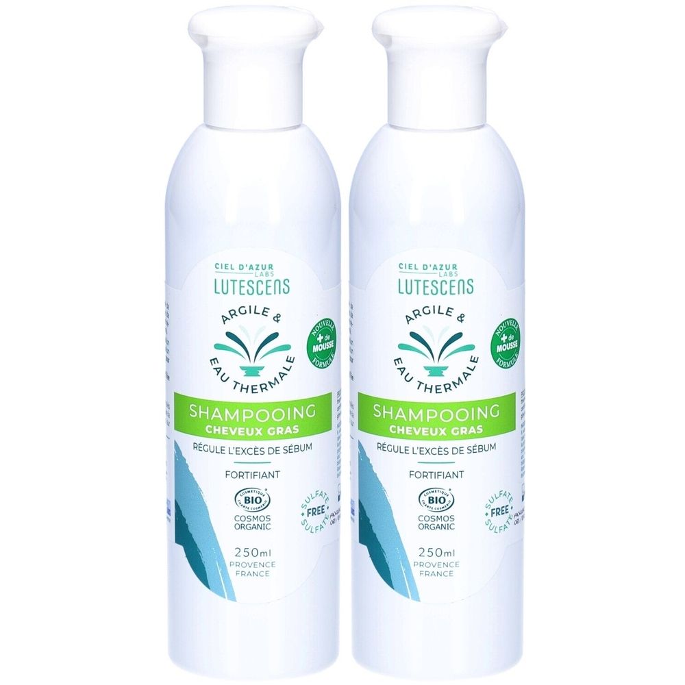 Twee witte shampoo flessen. Opschrift: Lutescens, Argile & Eau Thermale. Groen: Shampooing Cheveux Gras. Bio-certificering.