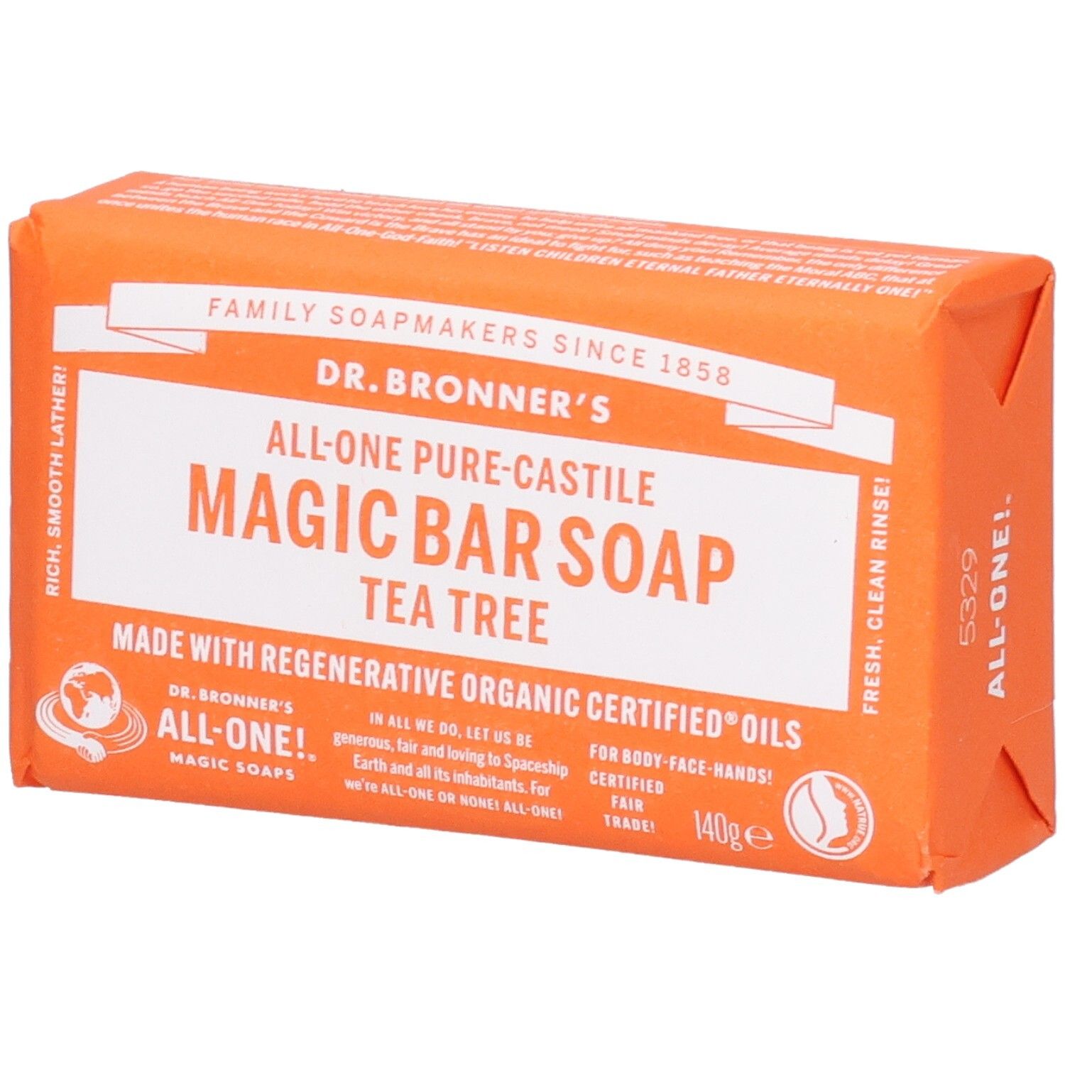 Oranje zeep in papieren verpakking. Opschrift: Magic Bar Soap Tea Tree. Fair Trade-label.