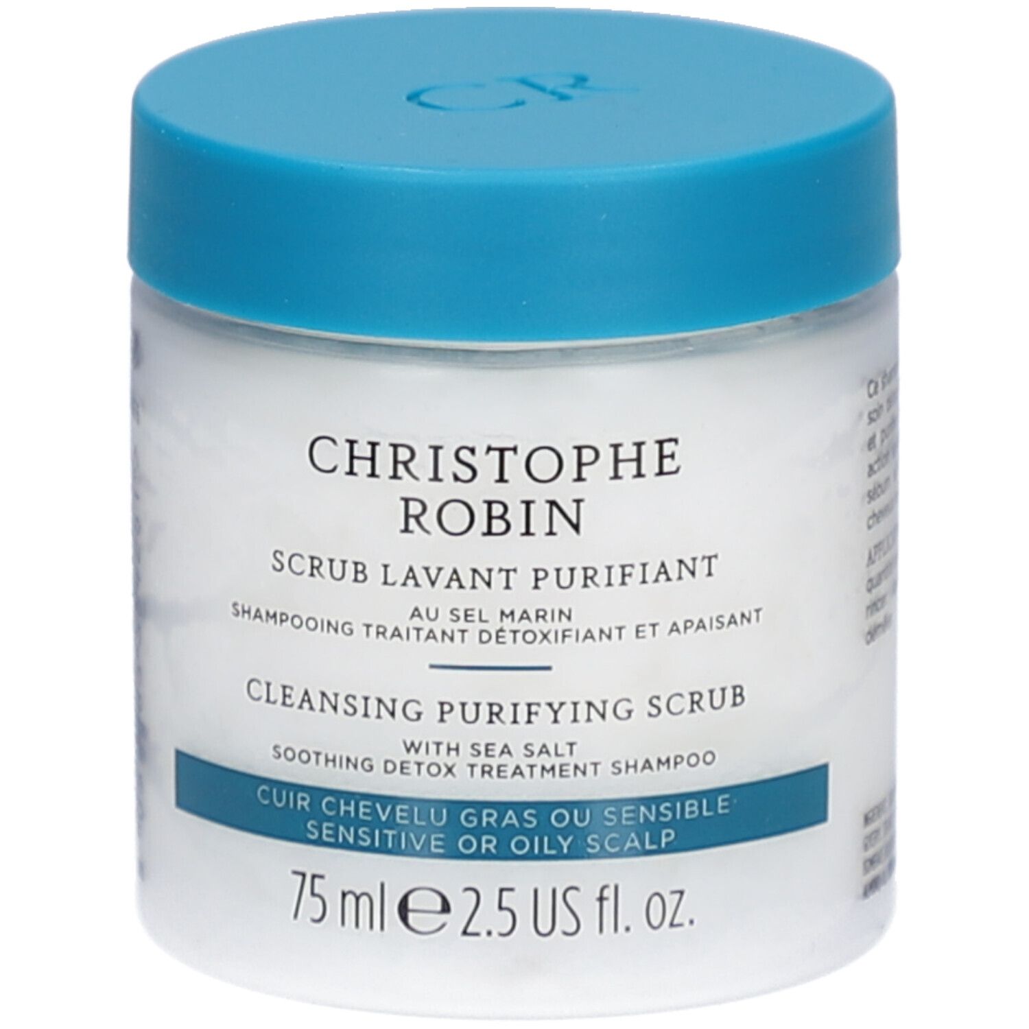 Witte pot met blauwe deksel. Opschrift: CHRISTOPHE ROBIN, SCRUB LAVANT PURIFIANT, CLEANSING PURIFYING SCRUB. Voor vette of gevoelige hoofdhuid.