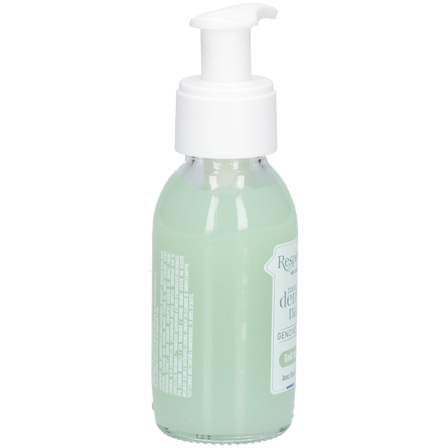 Glazen fles met witte pomp, gevuld met groene vloeistof. Etiket met tekst. Achteraanzicht.