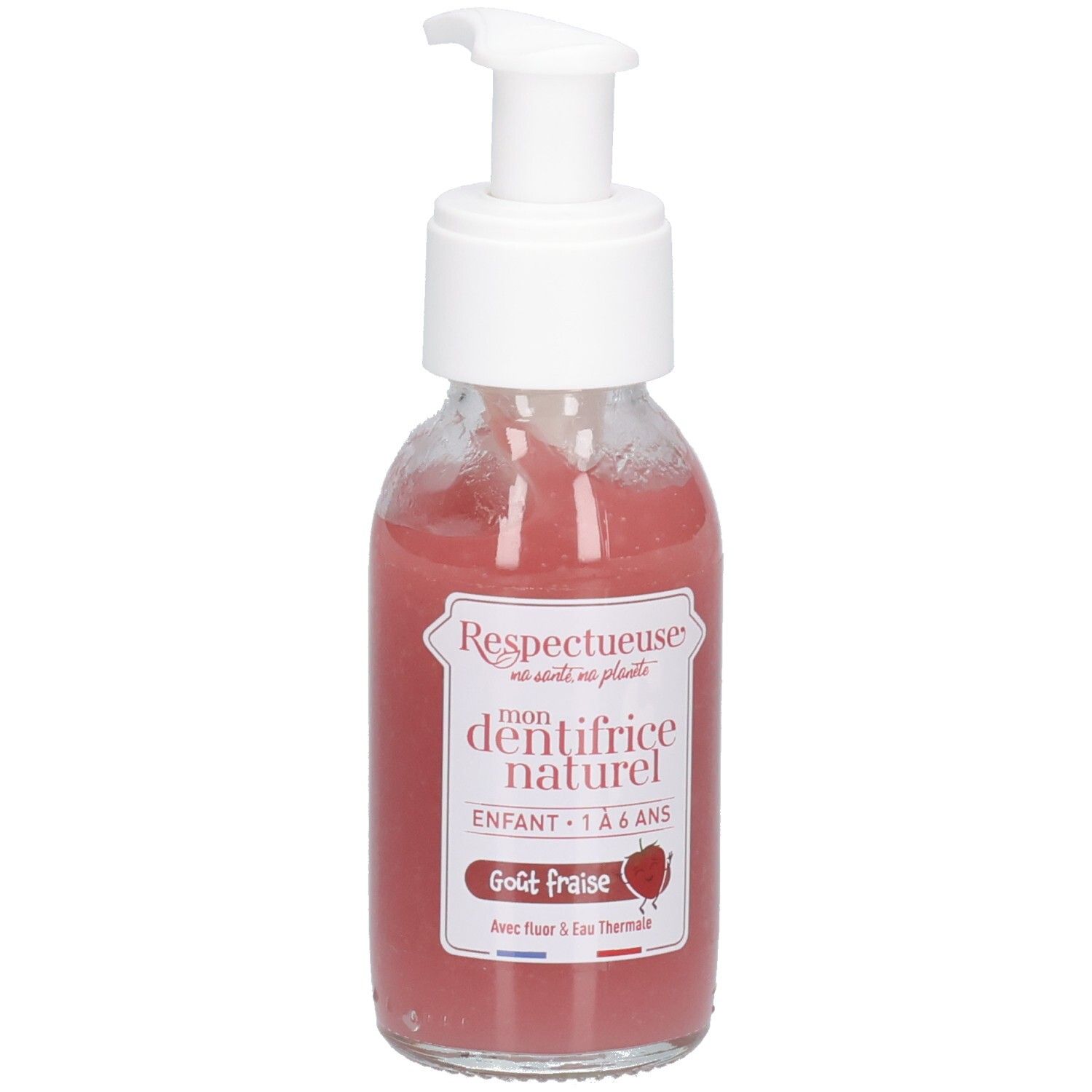 Roze vloeistof in glazen fles met witte pomp. Opschrift: "Respectueuse", "dentifrice naturel", "Goût fraise".