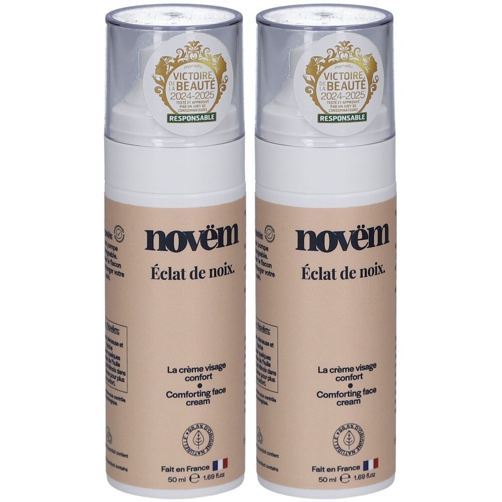 Twee crème flacons met transparante doppen. Opschrift: novèm, Éclat de noix, La crème visage confort, Comforting face cream. Label.