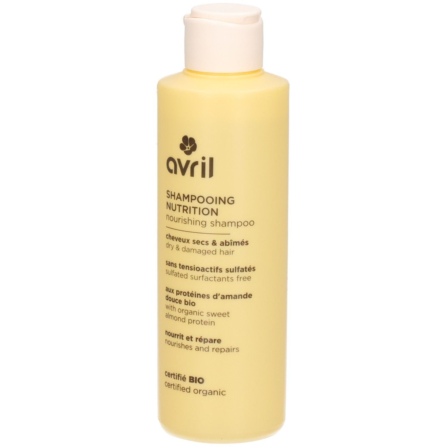 Lichtgele fles Avril Nourishing Shampoo met klapdeksel. Tekst op etiket: "SHAMPOOING NUTRITION", "dry & damaged hair", "sulfated surfactants free", "organic sweet almond protein", "certified organic".