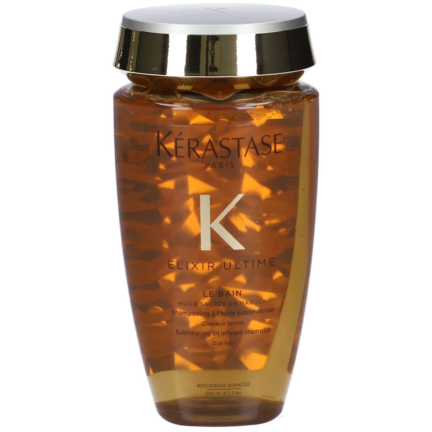 Bouteille de shampooing Kérastase Elixir Ultime avec bouchon doré. Liquide doré à l'intérieur.