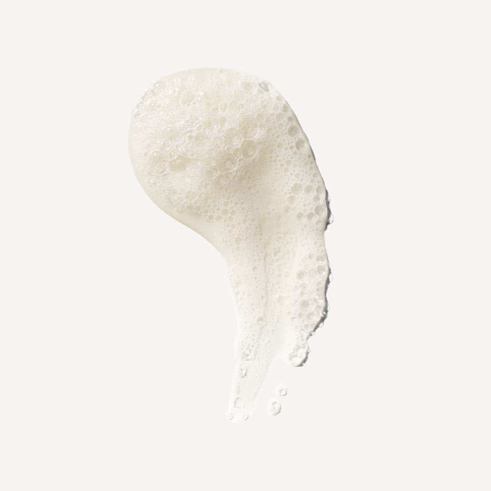 Une traînée de mousse blanche avec de petites bulles sur fond clair.
