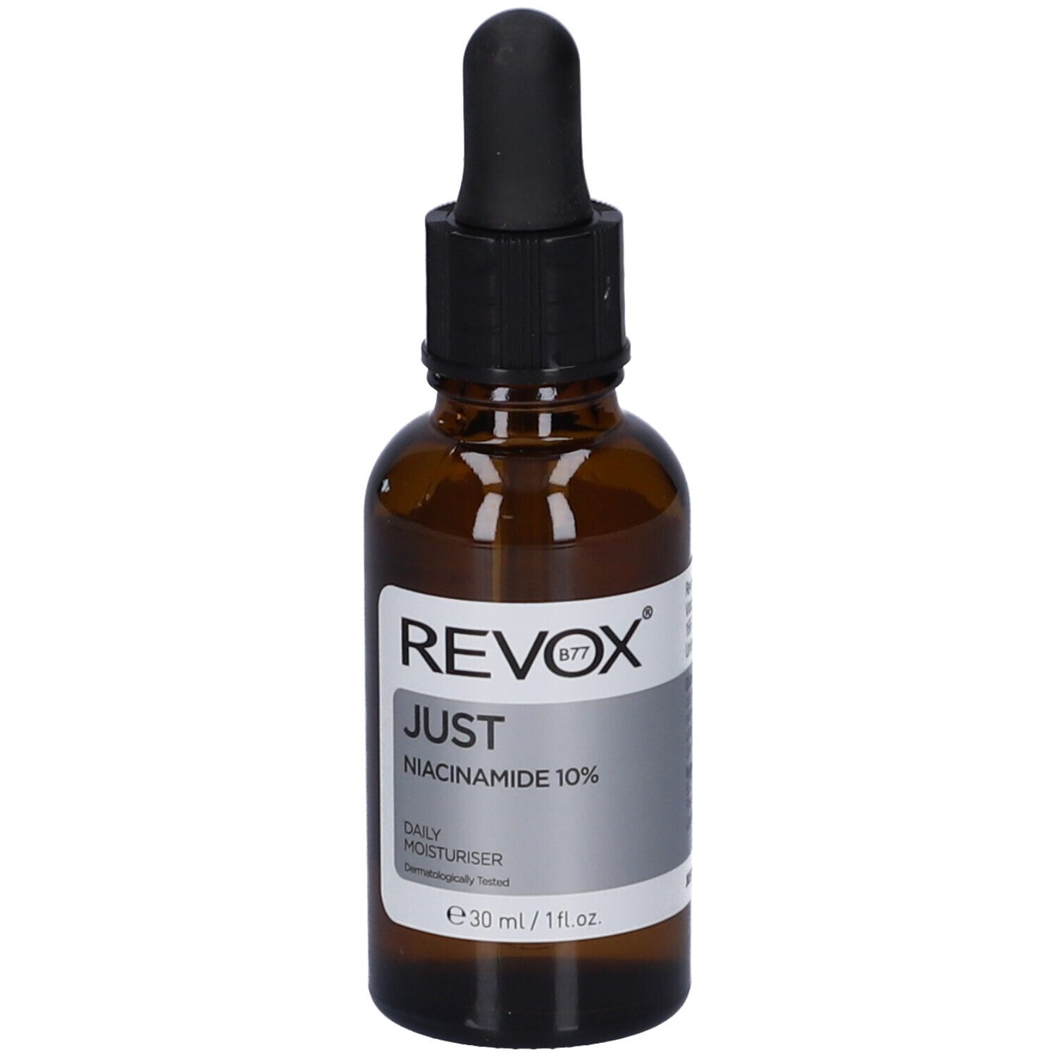 Flacon en verre brun avec compte-gouttes noir. Étiquette avec informations produit. Revox B77 Just Niacinamide 10%.
