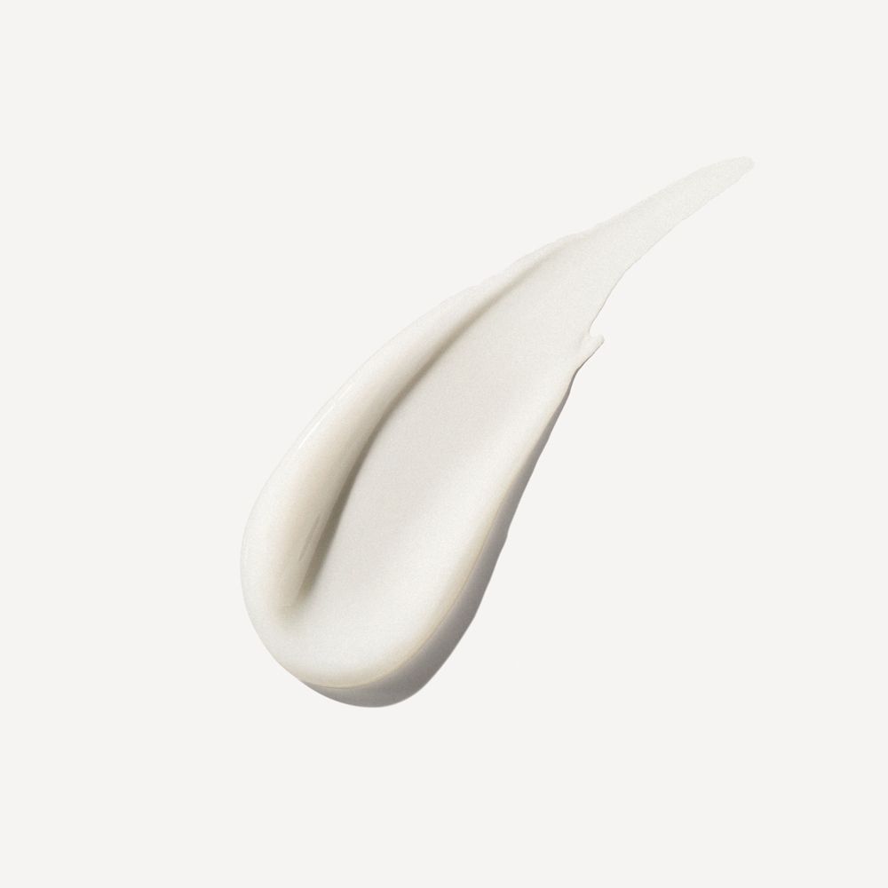 Uitvloeiing van haarproduct. Witte, romige textuur. Gladde, gebogen vorm. Op lichte achtergrond.