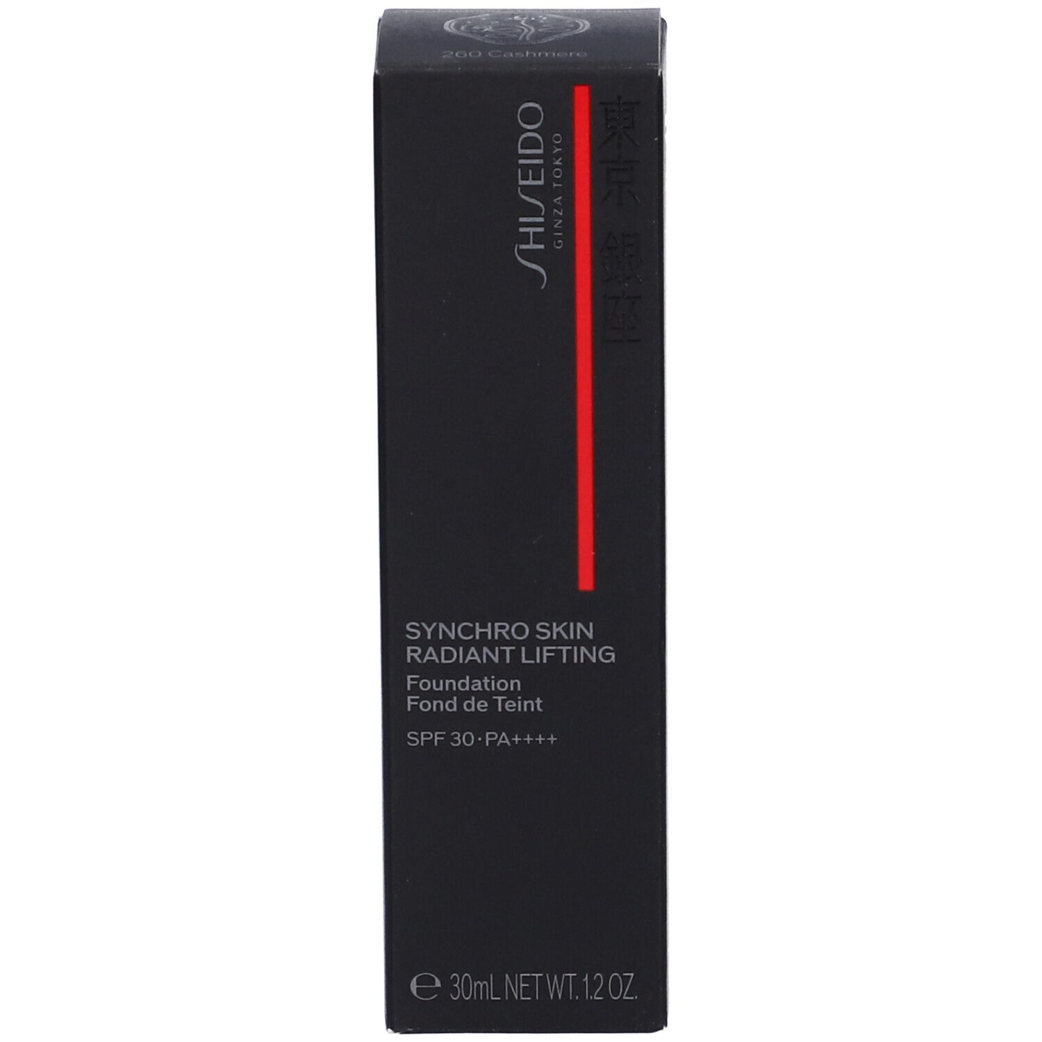 Emballage noir avec nom du produit, marque et indication SPF. Bande rouge.