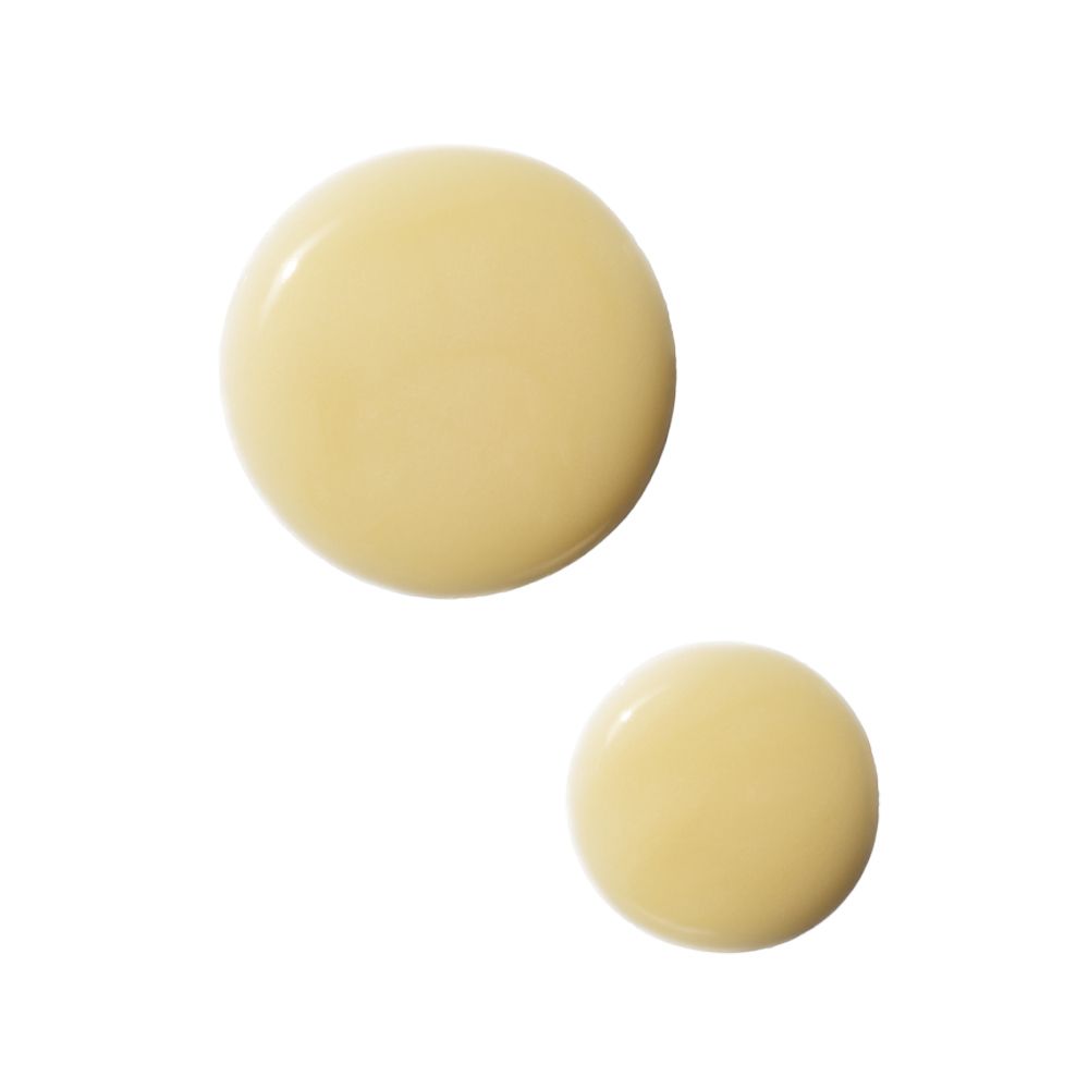 Deux gouttes de sérum jaunâtre sur fond blanc. Forme ronde.