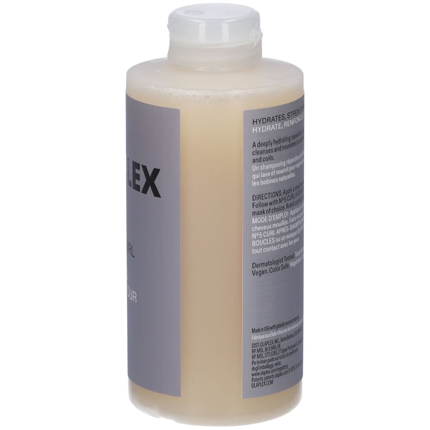 Bouteille de shampooing jaune pâle avec étiquette "OLAPLEX" et instructions.