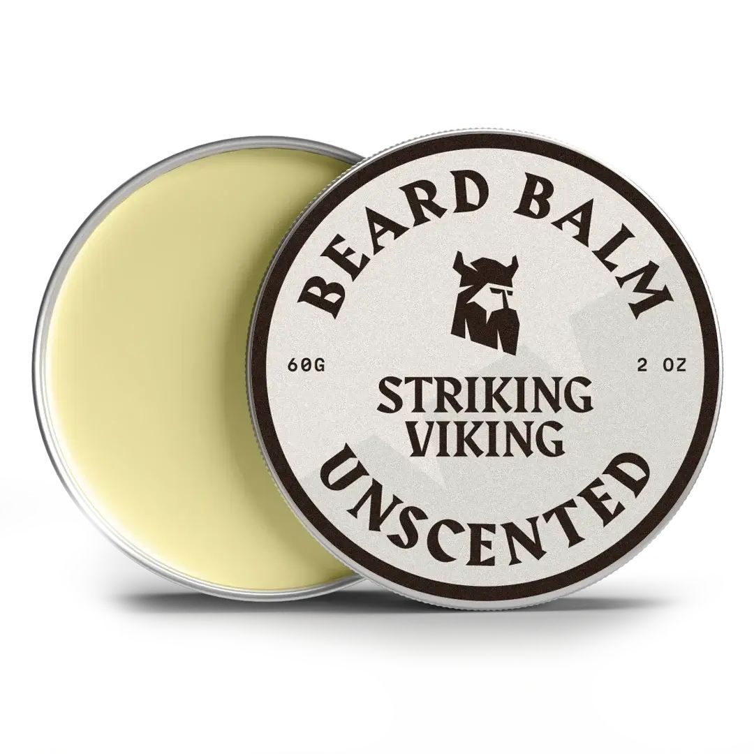 Boîte ronde de baume à barbe. Couvercle avec inscription: BEARD BALM, STRIKING VIKING, UNSCENTED. Contenu: 60g, 2 OZ. Boîte ouverte.