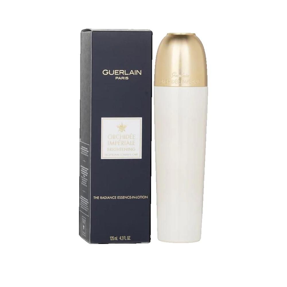 Flacon blanc avec bouchon doré à côté d'une boîte noire. La boîte porte l'inscription "GUERLAIN PARIS".