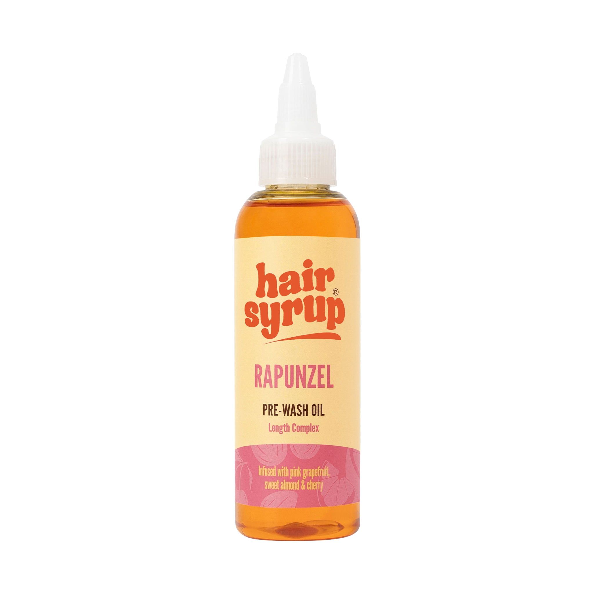 Hair Syrup Rapunzel Pre-Wash Oil fles. Gele vloeistof, witte dop, geel etiket met tekst.