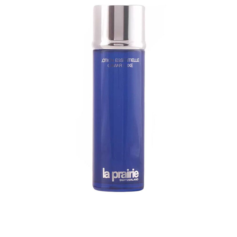 Blauwe fles met zilveren dop. Opschrift: Essence-in-Lotion. Merk: La Prairie.