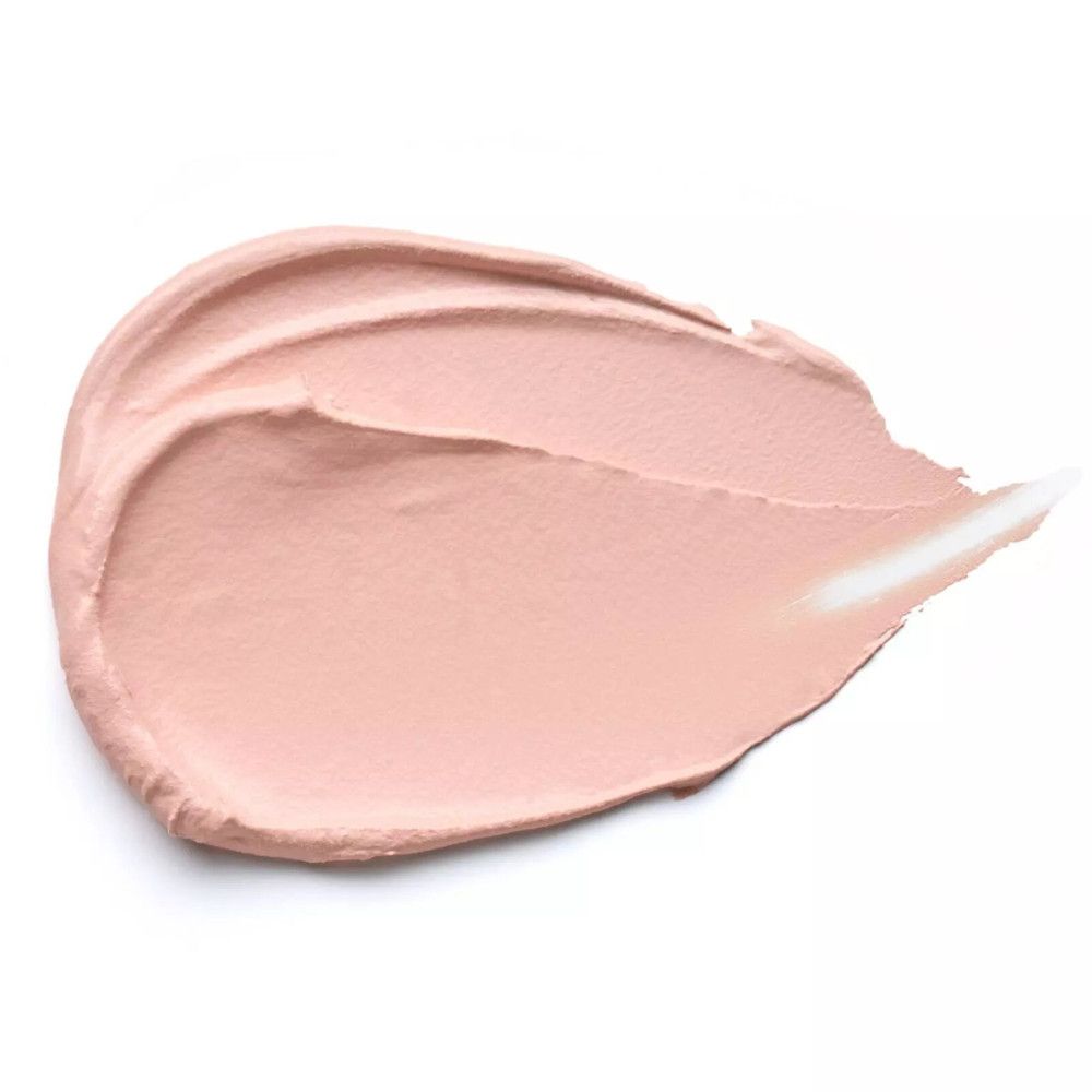 Roze crème-uitstrijk op witte achtergrond. Textuur zichtbaar.