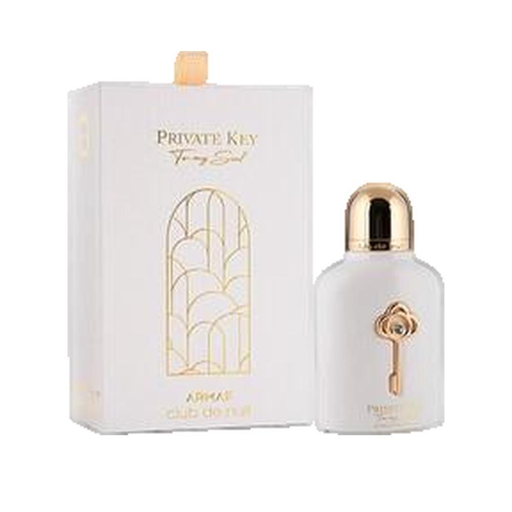 Wit parfumflesje met gouden dop en sleuteldecoratie. Daarnaast een witte doos met gouden opdruk.