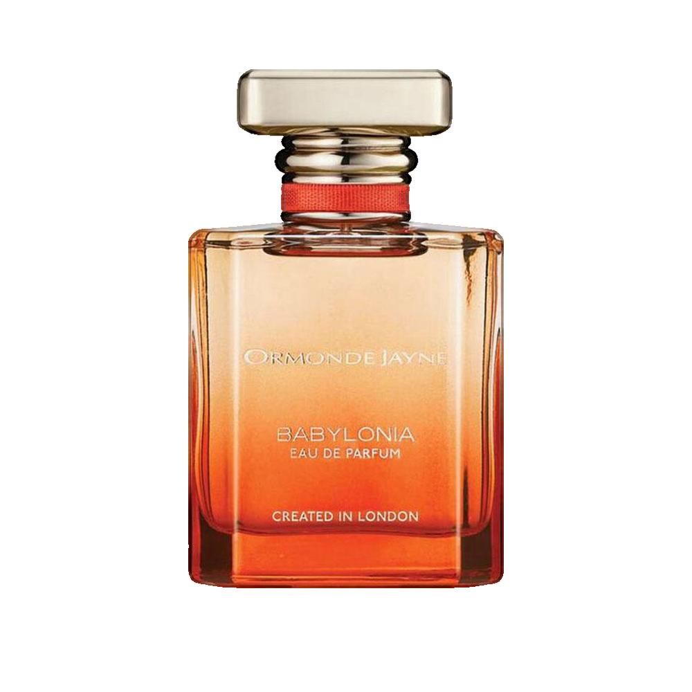 Flacon carré avec bouchon doré. Inscription: BABYLONIA EAU DE PARFUM. Fabriqué à Londres. Dégradé de couleurs orange et jaune.