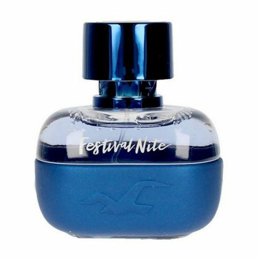 Flacon de parfum bleu. Le flacon indique "Festival Nite". Le flacon est de forme ronde et a un bouchon bleu.