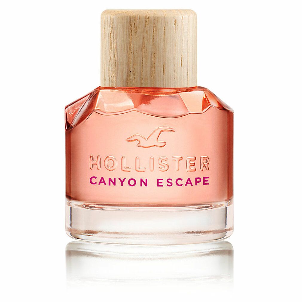 Fles Hollister Canyon Escape Eau de Parfum Spray. Roze vloeistof, houten dop. Logo en productnaam zichtbaar.