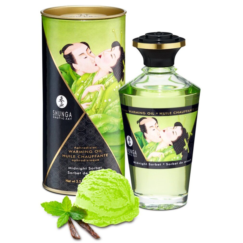 Flacon et emballage. Inscription: Shunga, Warming Oil, Midnight Sorbet. Crème glacée et herbes à côté.