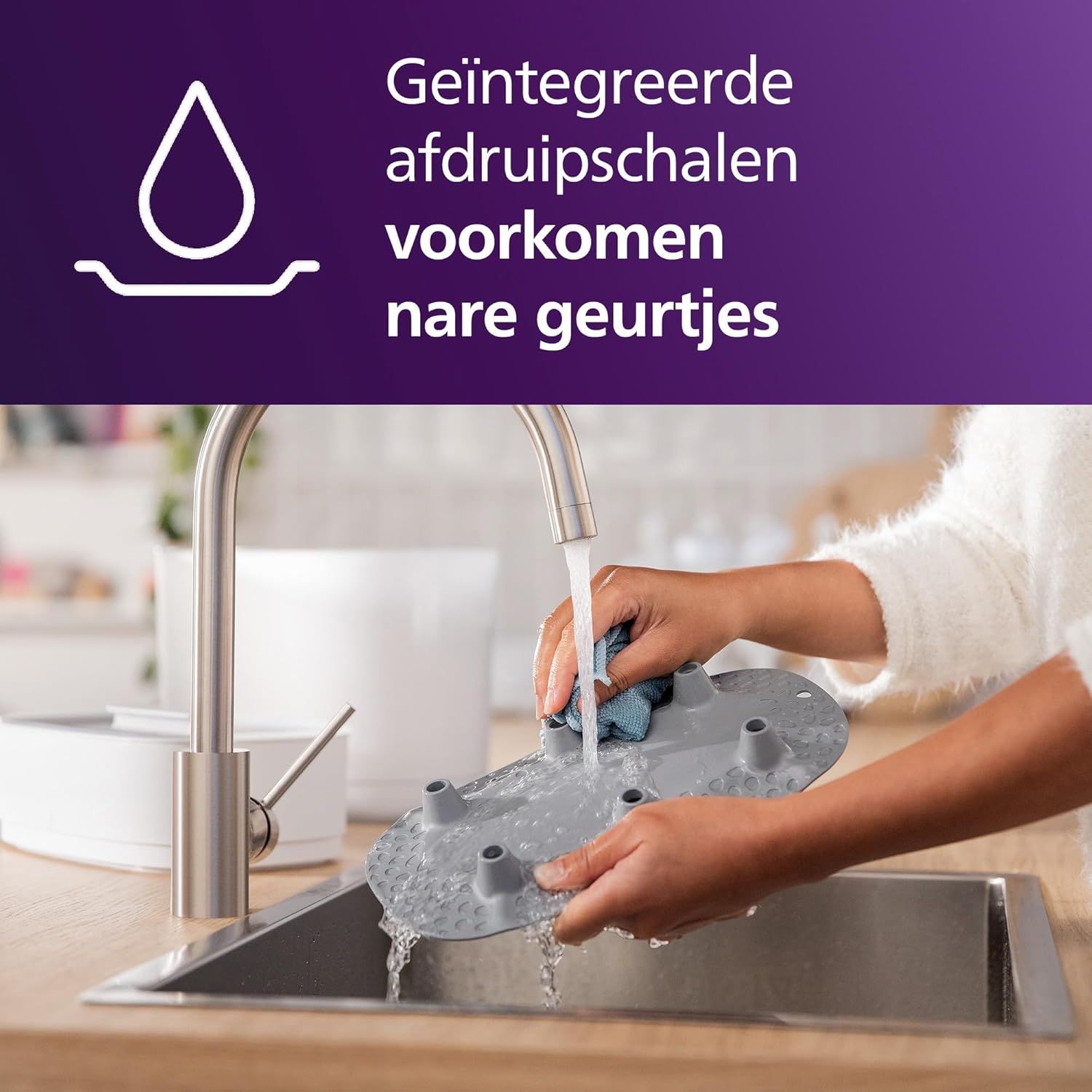 Philips Avent sterilisator op een aanrecht, met een paarse cirkel die '99,9%' aangeeft.