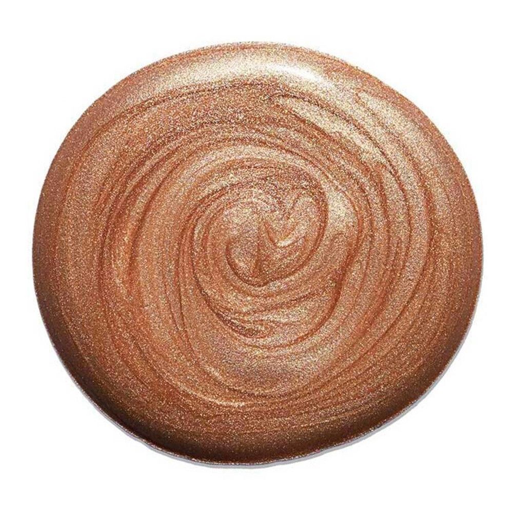 Cirkelvormige swatch van vloeibare highlighter. Goud-roze, glinsterende textuur. Draaipatroon.