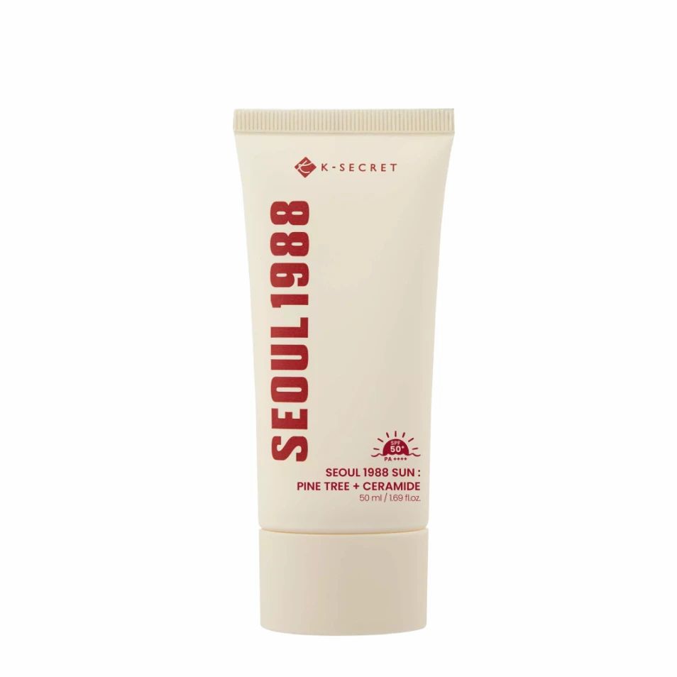 Witte tube met K-SECRET en SEOUL 1988 tekst. Bevat zonnebrandcrème.