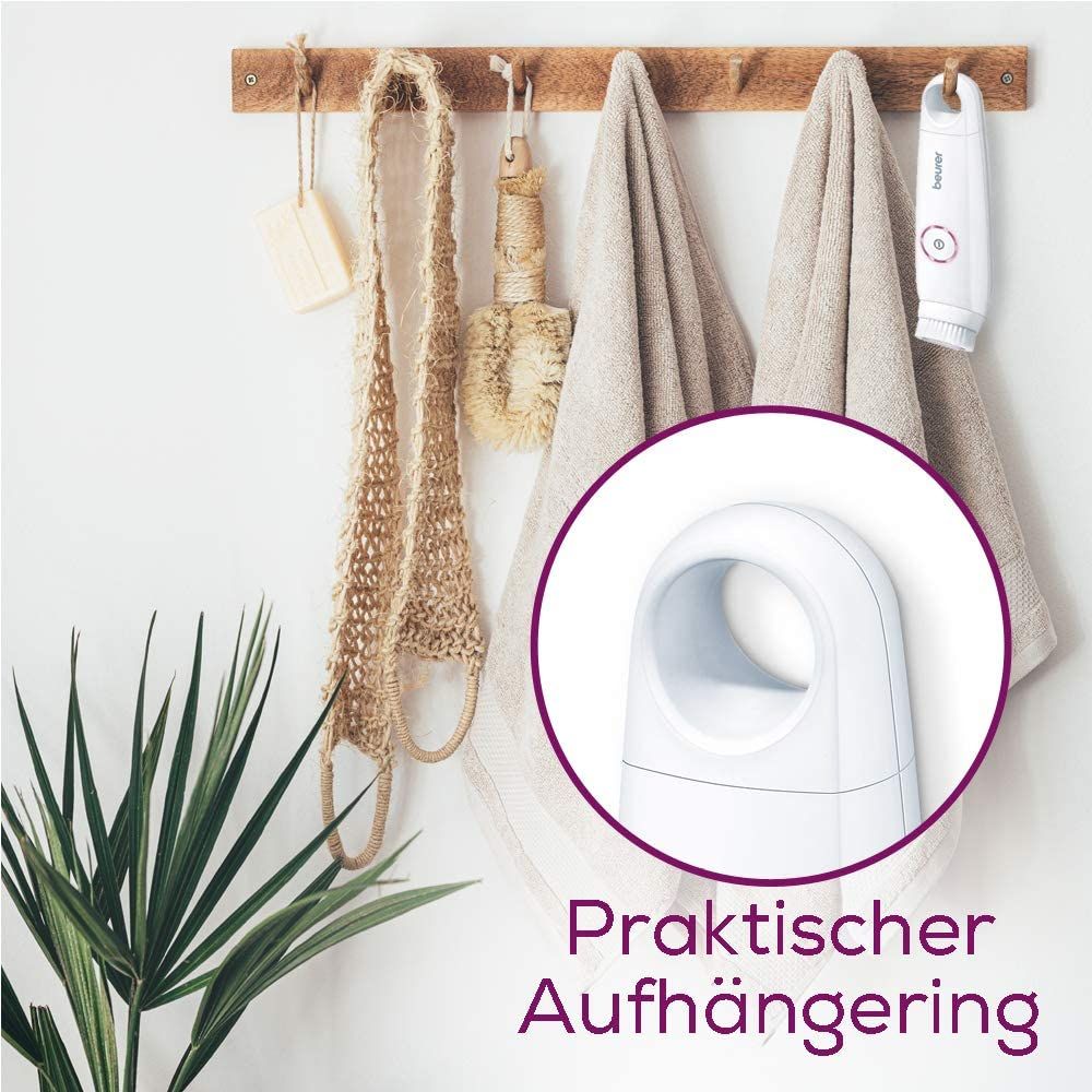 Gezichtsborstel aan haak. Wit apparaat met roze knop. Tekst: "Praktische ophangring".