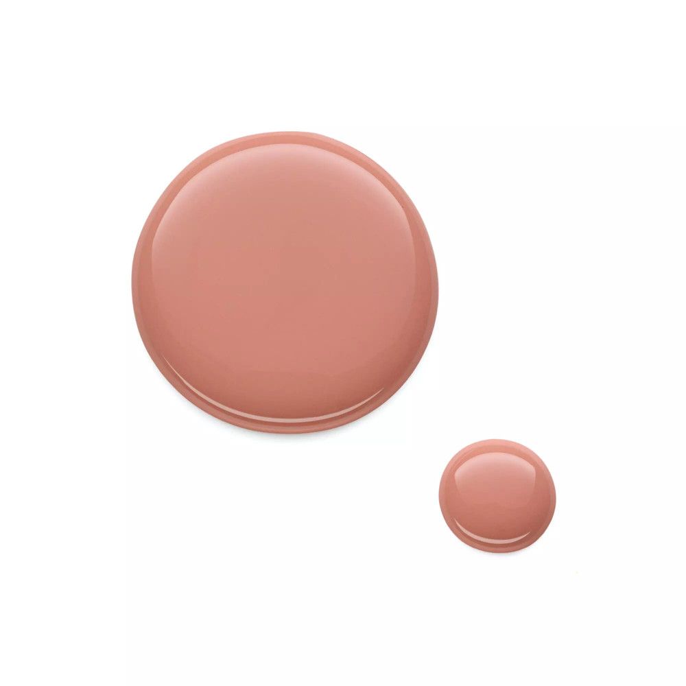 Deux gouttes de vernis à ongles roses sur fond blanc. Une grande et une petite goutte.