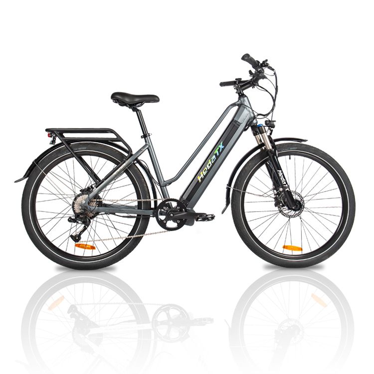 Vélo électrique gris HedaTX TX10. Pneus noirs, porte-bagages, selle. Logo HedaTX sur le cadre. Sur fond blanc.