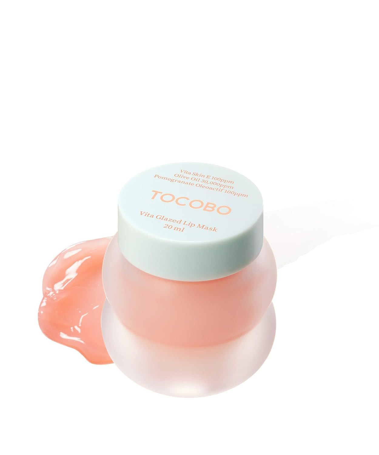 Pot rond avec couvercle, nom du produit et marque. Masque à lèvres rose. Texte : « TOCOBO Vita Glazed Lip Mask ».
