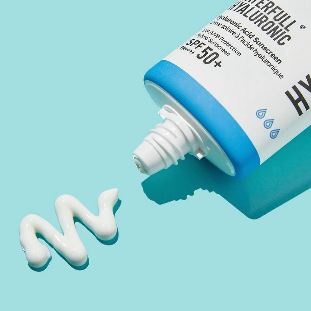 Witte tube, blauwe details, product wordt uitgeknepen. Opschrift: Water Full, Hyaluronic, SPF 50+. Crème-streep zichtbaar.