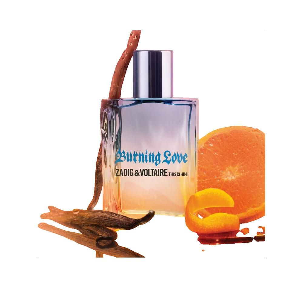 Parfumfles met opschrift Burning Love, Zadig & Voltaire This Is Him! naast kaneelstok en sinaasappelschijf.