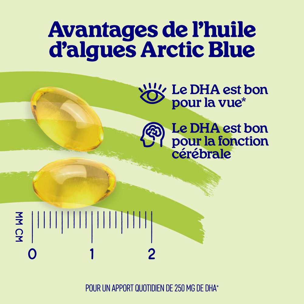 Deux capsules d'huile d'algues jaunes à côté d'une règle millimétrée montrant leur taille.
