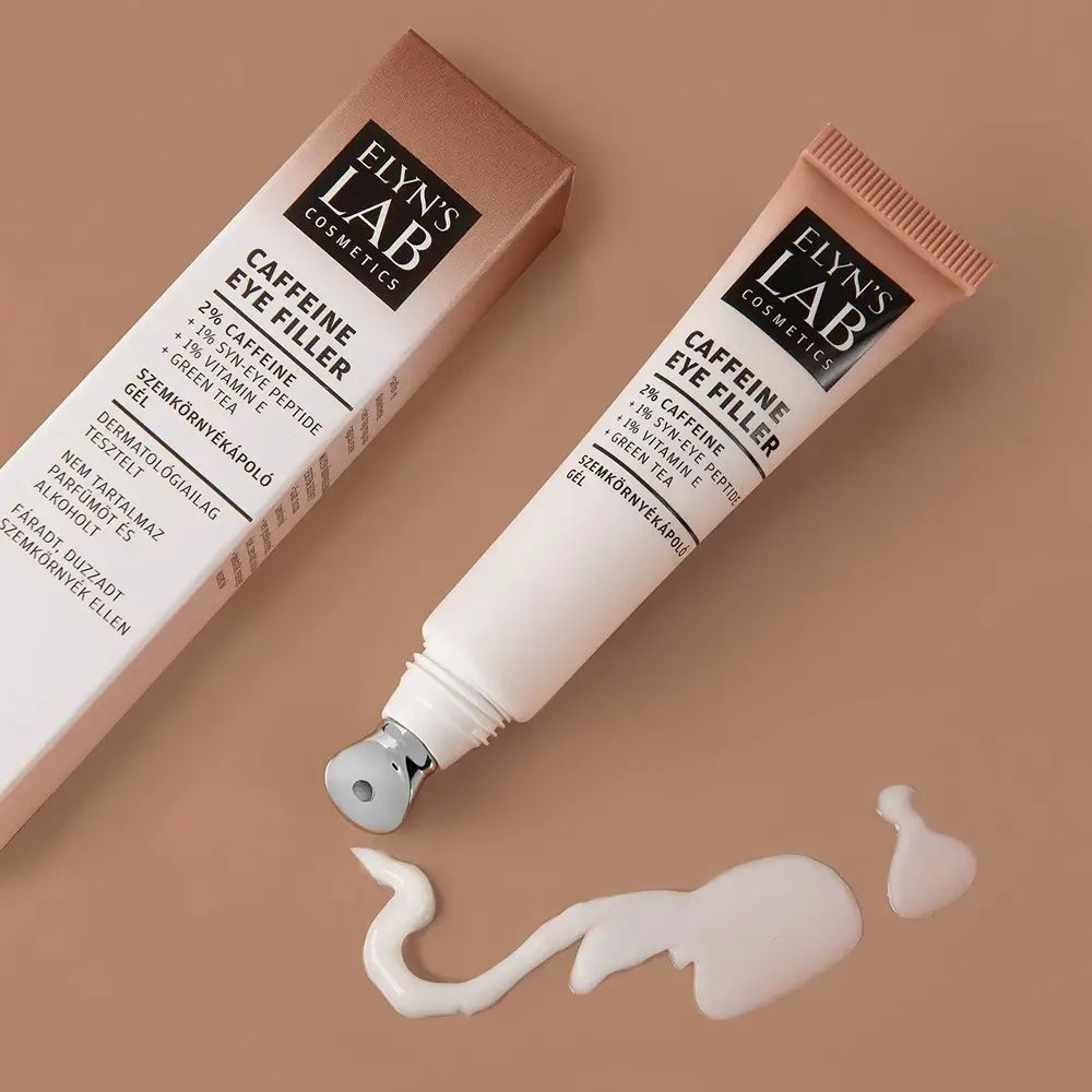 Tube met roll-on applicator en verpakking. Naam: ELYN'S LAB Caffeine Eye Filler. Klodder crème ernaast.