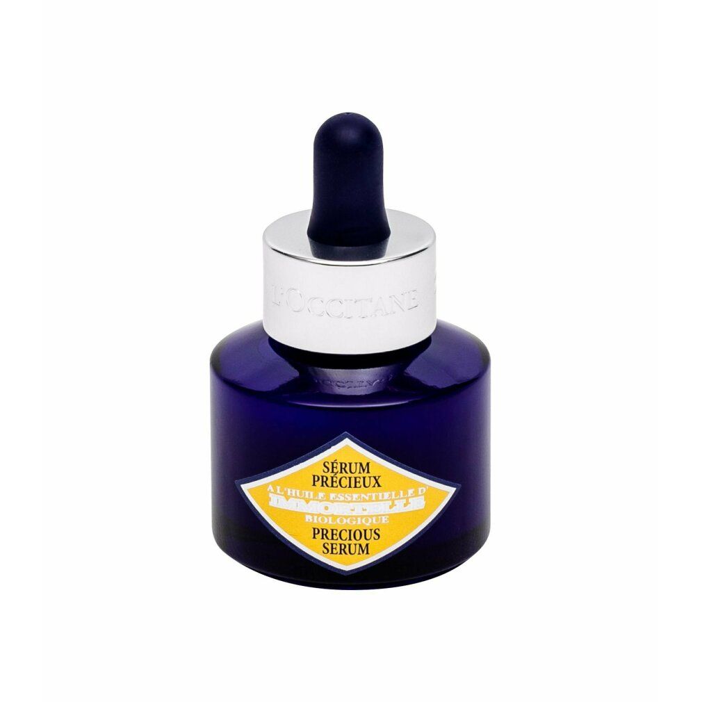 Donkerblauwe fles met zilveren dop en pipet. Geel etiket met tekst. Productnaam: Sérum Précieux.