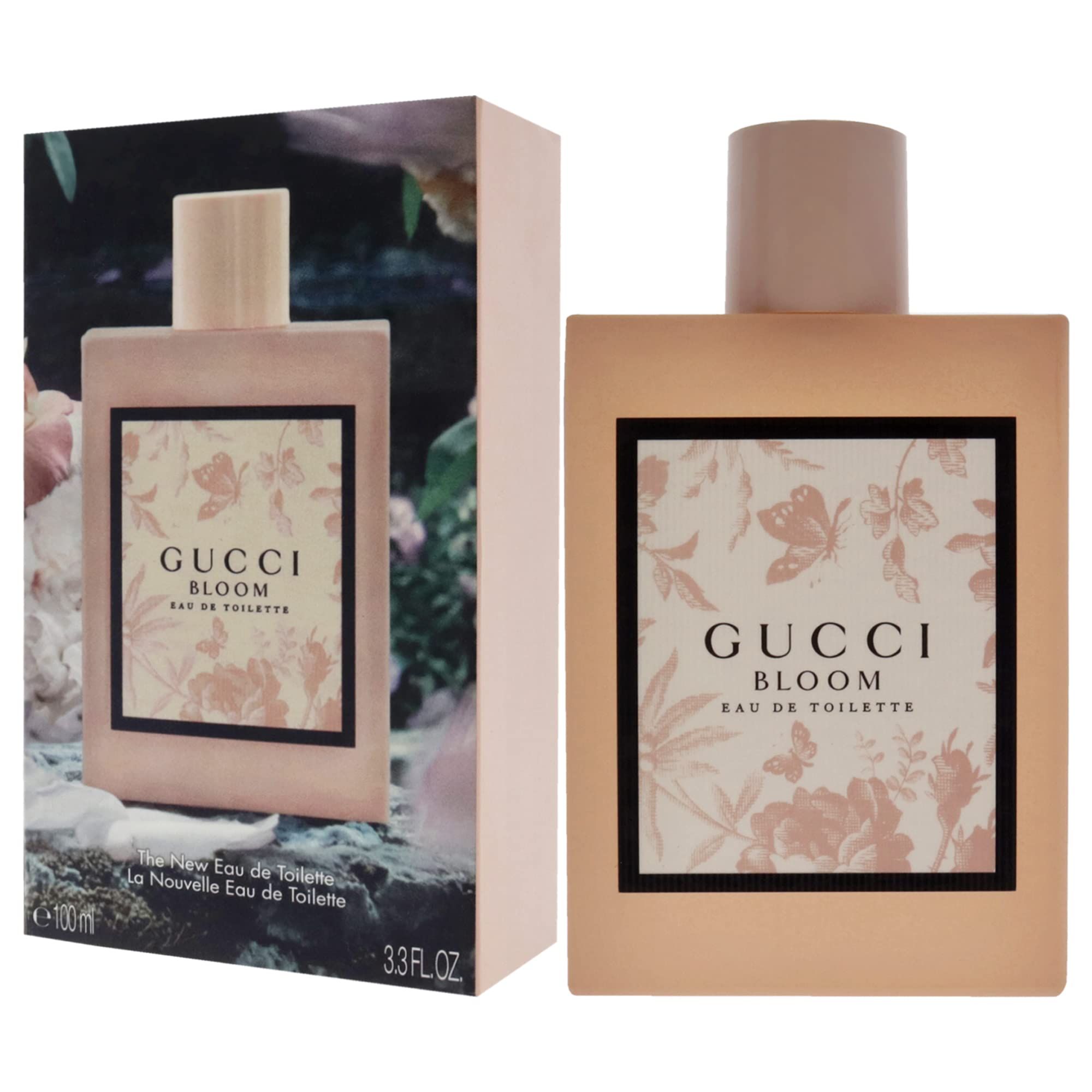 Roze fles en doos. Opschrift Gucci Bloom. Zwarte kader met bloemmotief. Eau de Toilette.