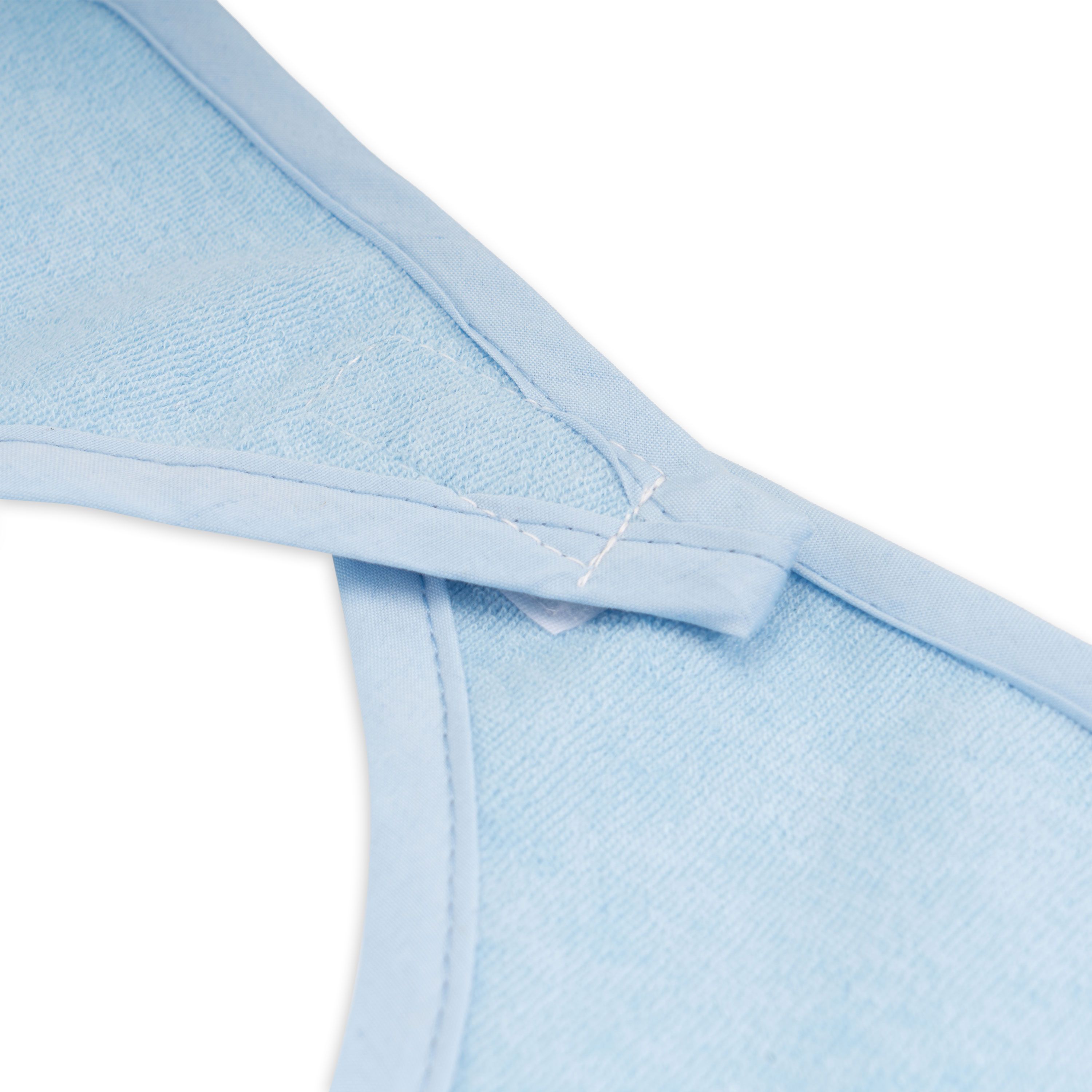 Détail de la fixation velcro au cou d'une bavette bleu clair. Velcro blanc.