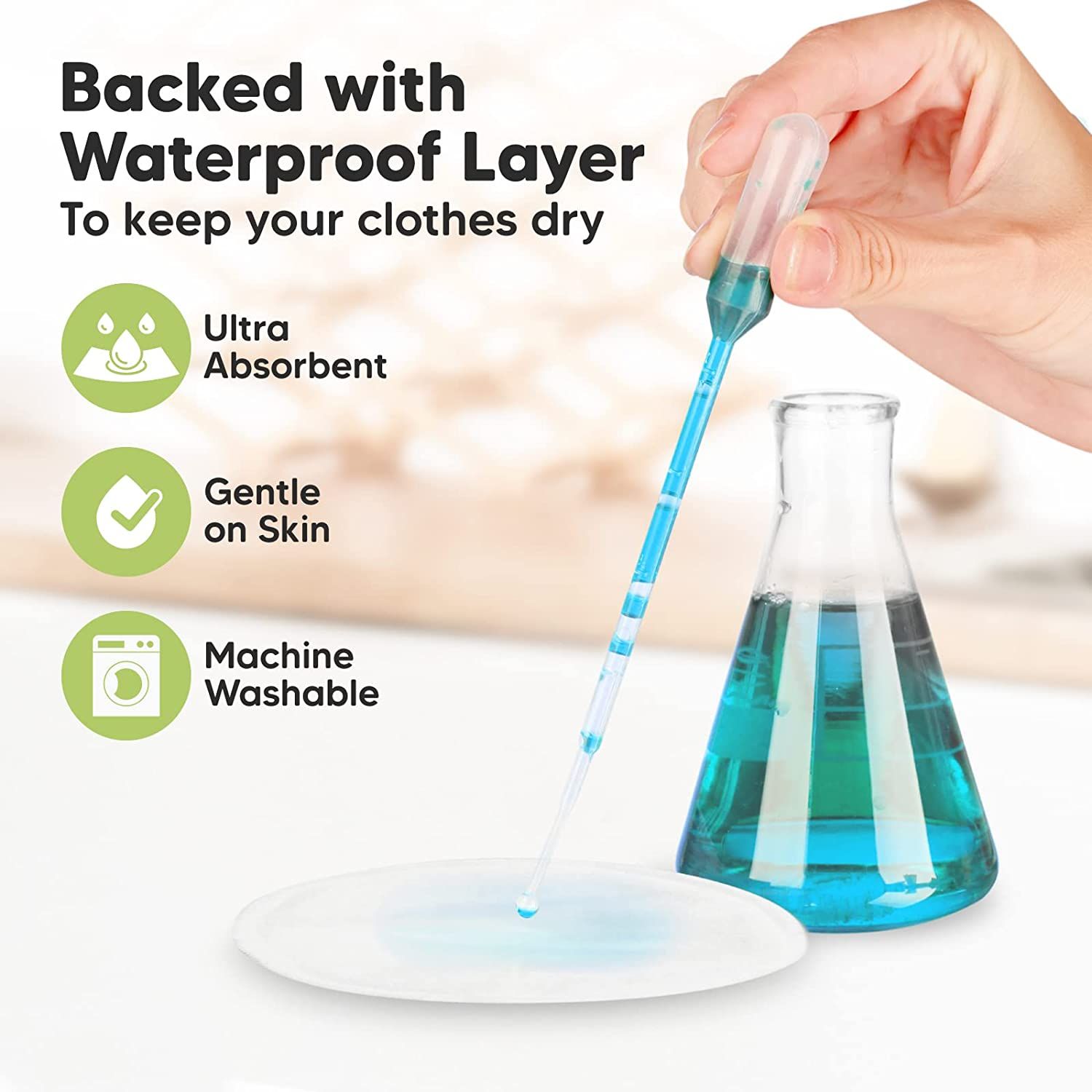 Zoogcompres met druppel. Opschrift: Ultra Absorbent, Gentle on Skin, Machine Washable. Laboratoriumfles en pipet.