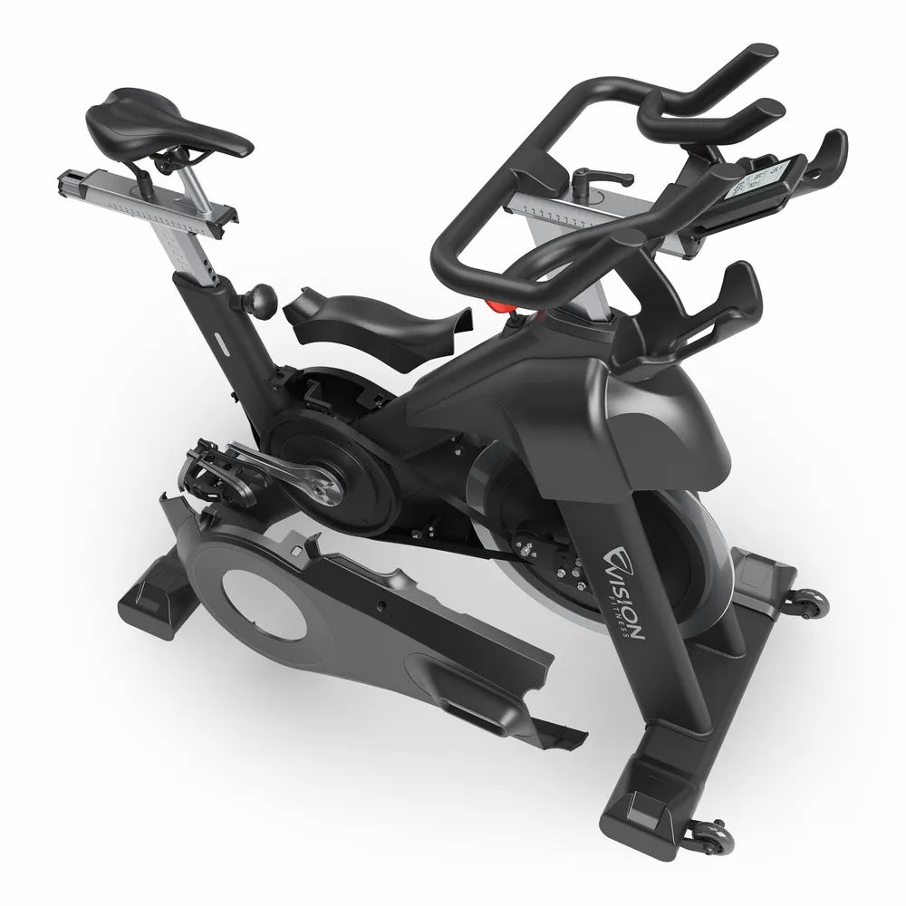 Indoorfiets met verwijderde afdekkingen. Zichtbaar: vliegwiel, pedalen, frame en Vision-logo.