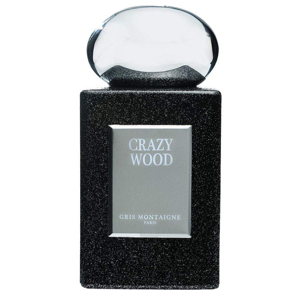 Donkergrijze flacon met zilveren etiket. Opschrift: CRAZY WOOD, GRIS MONTAIGNE PARIS. Transparante sluiting.