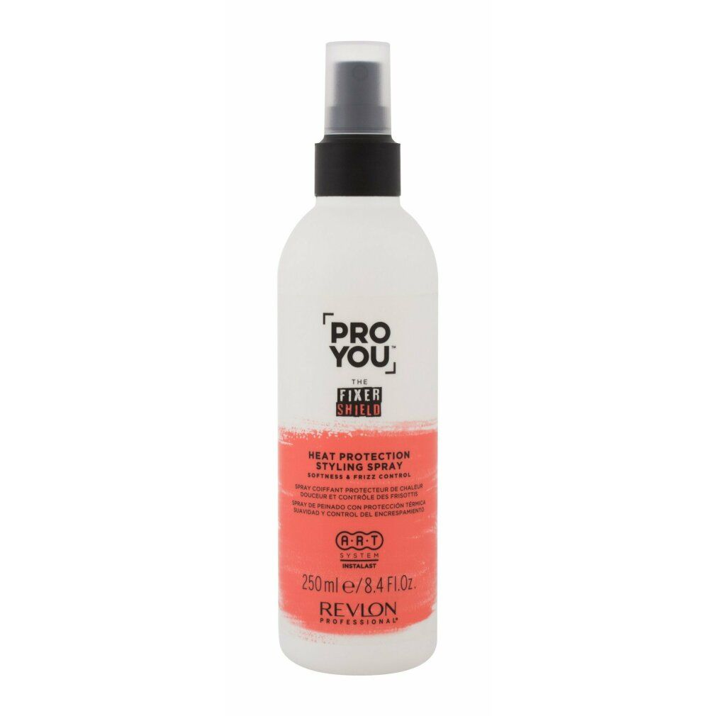 Flacon spray blanc et rouge. Inscription: PRO YOU THE FIXER SHIELD, Heat Protection Styling Spray, Revlon Professional. Tête de pulvérisation noire.