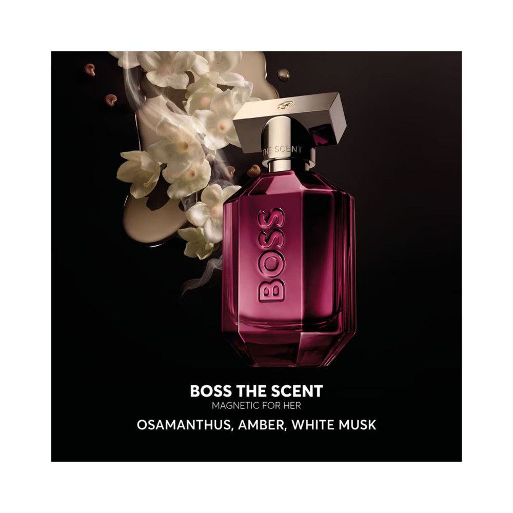 BOSS The Scent Magnetic EDP fles. Roze, hoekig, gouden dop. Opschrift BOSS. Bloemen en mist op de achtergrond.