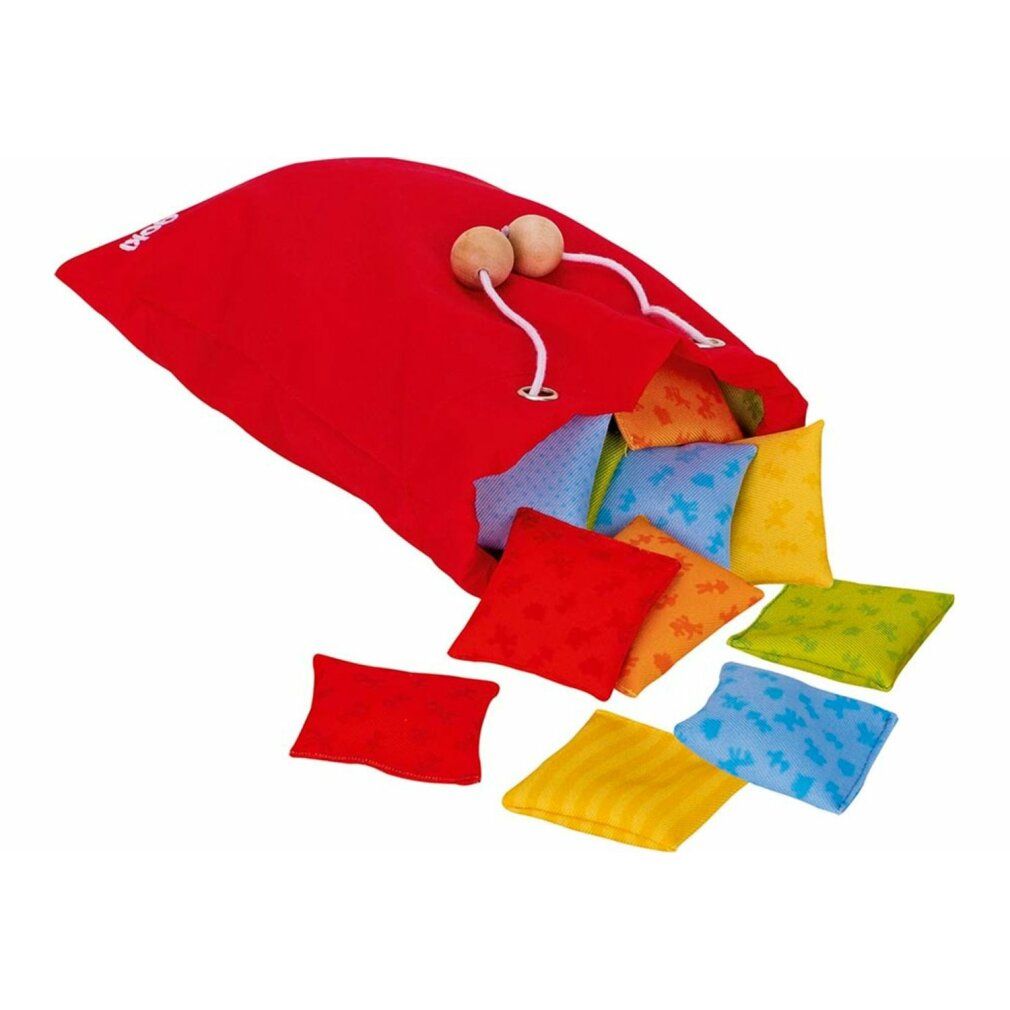 Sac rouge avec cordon contenant des coussins carrés colorés. Quelques coussins sont éparpillés.