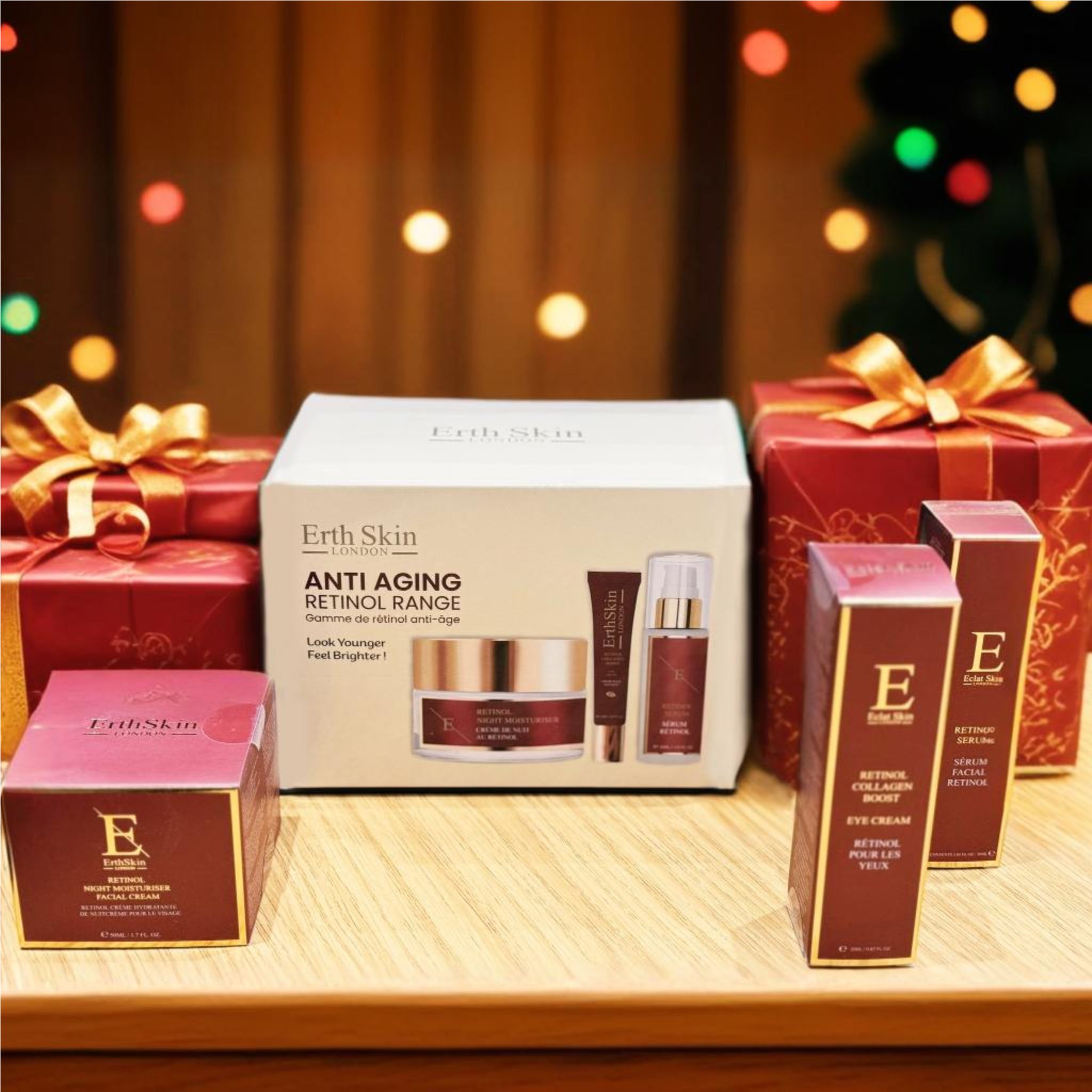 Coffret de soins de la peau entouré de coffrets cadeaux. Contient crème, sérum et crème pour les yeux. Inscription : Anti-Aging Retinol Range.