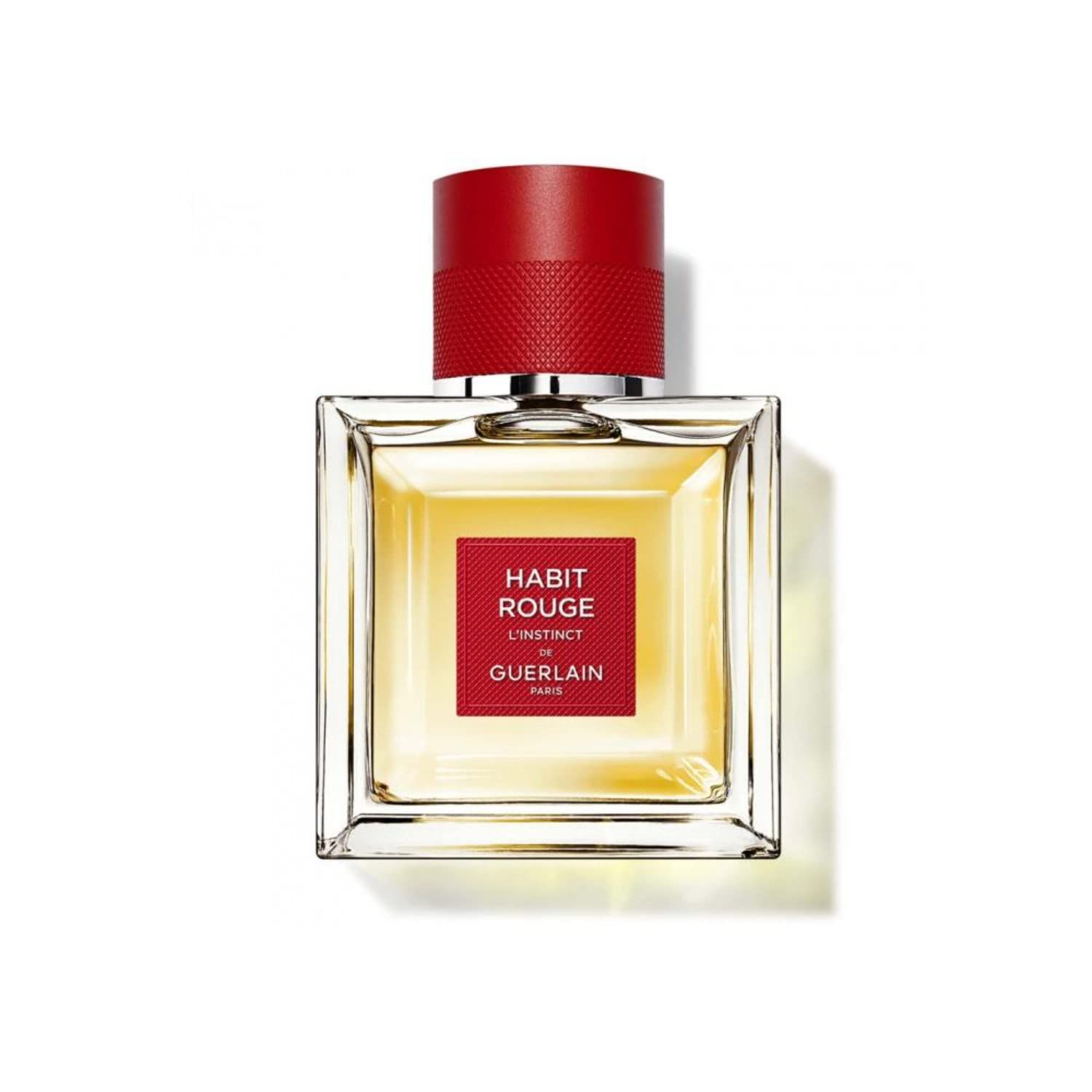 Vierkante flacon met rode dop. Rood etiket met tekst: Habit Rouge L'Instinct, Guerlain Paris. Transparante vloeistof.